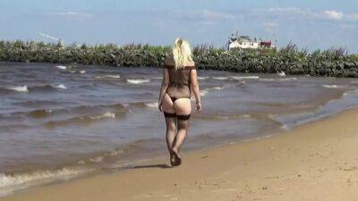 Pretty Woman In A Nylon Bodysuit On The Beach on youpornvideos.one