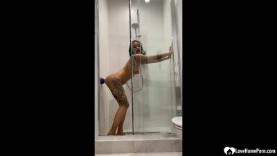 Tattooed teen gril fucking her sex toy in the shower on youpornvideos.one