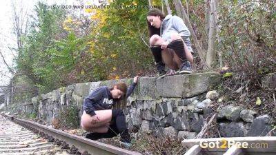 Watch these kinky girls get soaked in pee while getting frisky on the railway on youpornvideos.one