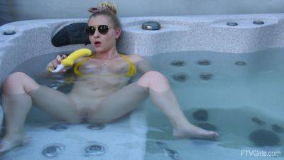 Sweet blonde inserts big dildo in her shaved pussy while in the pool on youpornvideos.one